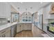 Spacious kitchen features stainless steel appliances, modern cabinets, and scenic backyard views at 1203 Crooked Oak Dr., Pawleys Island, SC 29585