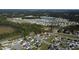 Aerial view of a residential neighborhood with houses, trees, and a pond, shown in sunny weather at 1220 Alcazar Ct., Conway, SC 29527