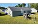 Backyard view with a small playground and a spacious lawn, attached to a light green house at 1220 Alcazar Ct., Conway, SC 29527