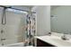Bathroom with a shower-tub combo, patterned curtain, sink with dark cabinets, and a mirror at 1220 Alcazar Ct., Conway, SC 29527