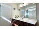 Bright bathroom featuring white countertops, wooden cabinets and tub with shower at 1220 Alcazar Ct., Conway, SC 29527