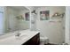 Bathroom featuring white countertops, dark cabinets, toilet, mirror and decorative artwork at 1220 Alcazar Ct., Conway, SC 29527