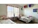 Cozy bedroom showcasing two twin beds, window with pink drapes, and decorative accents at 1220 Alcazar Ct., Conway, SC 29527