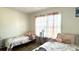 Bright bedroom with two twin beds, soft pink accents, a window with pink curtains, and hardwood floors at 1220 Alcazar Ct., Conway, SC 29527