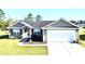 Charming single Gathering home with two-car garage, manicured lawn and attractive landscaping at 1220 Alcazar Ct., Conway, SC 29527