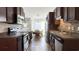 Galley style kitchen features stainless appliances, dark cabinets, and adjacent dining area at 1220 Alcazar Ct., Conway, SC 29527