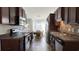 Galley style kitchen features stainless appliances, dark cabinets, and adjacent dining area at 1220 Alcazar Ct., Conway, SC 29527