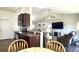 Open concept living room flows seamlessly into kitchen featuring vaulted ceiling and dark wood floor at 1220 Alcazar Ct., Conway, SC 29527