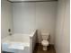 Bathroom view featuring a white tub with steps and a standard toilet at 1242 Carrie Bell Ln, Myrtle Beach, SC 29577