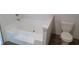 Bathroom featuring a white tub with tiled steps, a privacy wall, and a toilet at 1242 Carrie Bell Ln, Myrtle Beach, SC 29577