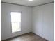 Bright bedroom features vinyl floors, a window, and white walls at 1242 Carrie Bell Ln, Myrtle Beach, SC 29577