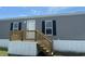 Close-up of manufactured home entrance with new wooden deck and stairs at 1242 Carrie Bell Ln, Myrtle Beach, SC 29577