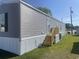 Exterior view of manufactured home with long gray siding and wooden porch at 1242 Carrie Bell Ln, Myrtle Beach, SC 29577