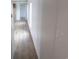 A view down the long hallway with wood-look flooring and white walls at 1242 Carrie Bell Ln, Myrtle Beach, SC 29577