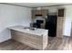 Bright kitchen with island, sink, and matching appliances and wood cabinets at 1242 Carrie Bell Ln, Myrtle Beach, SC 29577