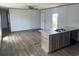 Open living room with kitchen island and sink, and luxury vinyl flooring at 1242 Carrie Bell Ln, Myrtle Beach, SC 29577