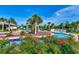 Scenic view of a meandering lazy river, bordered by colorful flowers and tropical palm trees at 1286 Culbertson Ave., Myrtle Beach, SC 29577