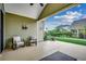 Back patio with two chairs, green siding, and a view of the green lawn at 1286 Culbertson Ave., Myrtle Beach, SC 29577