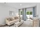 Sun-filled living room showcases stylish decor, a comfortable sofa, and sliding glass doors to a patio at 132 Hoffman Park Dr. # 13, Myrtle Beach, SC 29588