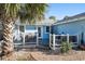 Backyard patio with outdoor dining, lounge seating and mature palms at 1415 Edge Dr., North Myrtle Beach, SC 29582