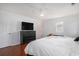 A primary bedroom featuring a tv over a black chest of drawers, wood flooring and a ceiling fan at 1415 Edge Dr., North Myrtle Beach, SC 29582