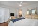A bedroom with wood floors, ceiling fan, large closets, and adjacent view to other rooms at 1415 Edge Dr., North Myrtle Beach, SC 29582