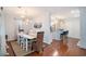 Bright dining room with modern chandelier, white table set for six, and hardwood floors at 1415 Edge Dr., North Myrtle Beach, SC 29582