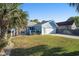 Charming blue house featuring an attached garage and a lush, green lawn at 1415 Edge Dr., North Myrtle Beach, SC 29582