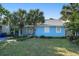 Charming blue house framed by mature trees and a beautifully maintained lawn at 1415 Edge Dr., North Myrtle Beach, SC 29582