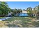 Charming blue house surrounded by lush, mature palm trees and a well-manicured lawn at 1415 Edge Dr., North Myrtle Beach, SC 29582