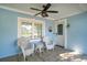 Cozy front porch with seating, a ceiling fan, and a beautifully painted blue exterior at 1415 Edge Dr., North Myrtle Beach, SC 29582