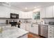 Bright kitchen featuring granite countertops, stainless steel appliances, and white cabinetry at 1415 Edge Dr., North Myrtle Beach, SC 29582
