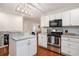 Modern kitchen with white cabinets, granite countertops, and stainless steel appliances at 1415 Edge Dr., North Myrtle Beach, SC 29582