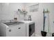 A laundry room with side-by-side washer and dryer and shelving for storage at 1415 Edge Dr., North Myrtle Beach, SC 29582