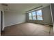 Bright bedroom featuring three windows offering serene lake views and ample natural light at 1430 Crested Iris Way, North Myrtle Beach, SC 29582