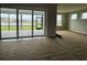 Bright living room with sliding glass doors leading to a screened porch and lake views at 1430 Crested Iris Way, North Myrtle Beach, SC 29582