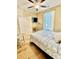 Cozy bedroom with hardwood floors, ceiling fan, and a mounted TV for relaxing evenings at 144 Puffin Dr. # 1-A, Pawleys Island, SC 29585