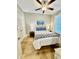 Comfortable bedroom with hardwood floors, ceiling fan and windows offering natural light at 144 Puffin Dr. # 1-A, Pawleys Island, SC 29585