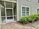 A view of the home's exterior with a screened porch, siding and landscaped yard at 144 Puffin Dr. # 1-A, Pawleys Island, SC 29585