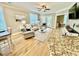 Cozy living room with comfortable seating, bright windows, and hardwood floors at 144 Puffin Dr. # 1-A, Pawleys Island, SC 29585