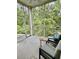 Inviting screened porch with comfortable seating and serene views of lush greenery at 144 Puffin Dr. # 1-A, Pawleys Island, SC 29585