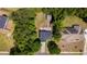 An aerial view of the home surrounded by trees, a backyard firepit and a storage shed at 1720 Horry St., Conway, SC 29526