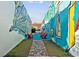 Colorful alley showcasing vibrant mural art, brick walkway, and cozy seating area for relaxation at 1720 Horry St., Conway, SC 29526