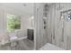 Elegant bathroom featuring a tiled shower, a modern vanity, and a window for natural light at 1720 Horry St., Conway, SC 29526