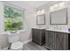 Bathroom featuring double vanities, modern fixtures, and a bright window at 1720 Horry St., Conway, SC 29526