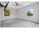 Bright bedroom featuring neutral walls, ceiling fan, and scenic views from two windows at 1720 Horry St., Conway, SC 29526