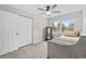 Cozy bedroom features a ceiling fan, large window with view, and closet for storage at 1720 Horry St., Conway, SC 29526