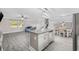 Open-concept living space with a kitchen island, gray flooring, and natural light at 1720 Horry St., Conway, SC 29526