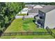 Aerial view of a home with a fenced backyard, including a playset, patio, and ample green space at 1748 Promise Pl., Myrtle Beach, SC 29588