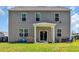 Exterior of home with large backyard, covered patio, and sliding glass doors at 1748 Promise Pl., Myrtle Beach, SC 29588